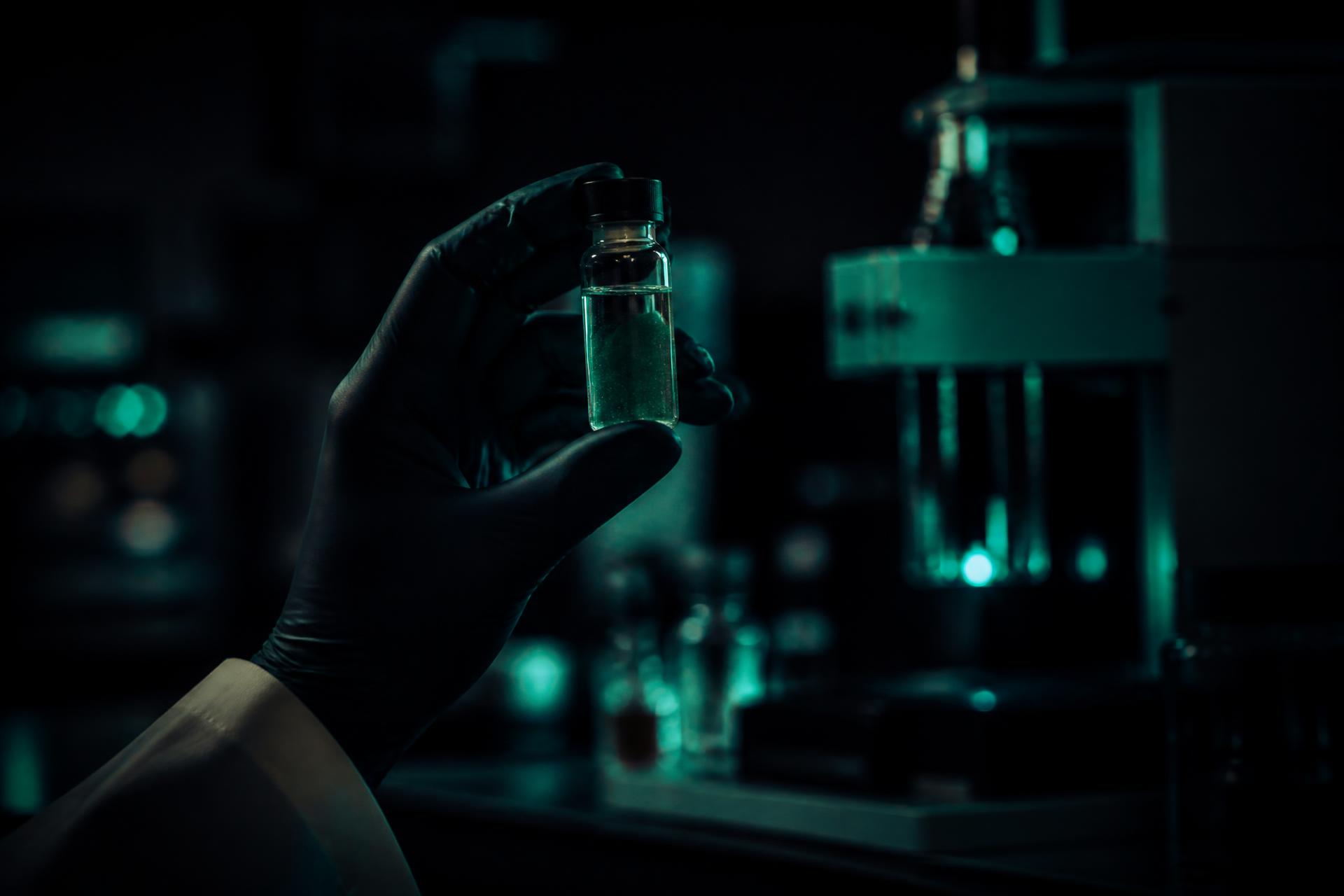 Analyst inspecting a sample vial in the Graviti laboratory