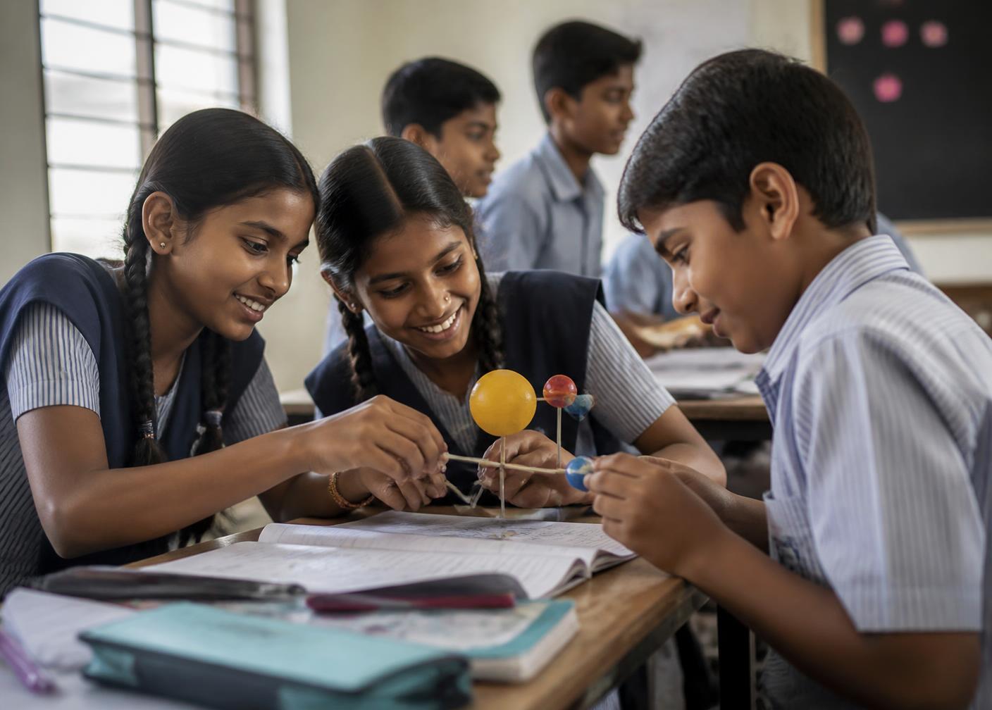Schoolchildren working together on a science model in a Graviti Foundation after-school class